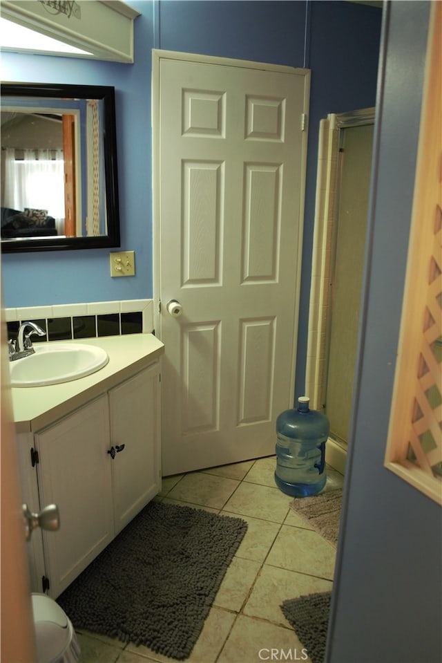 full bath featuring an enclosed shower, tile patterned floors, vanity, and toilet