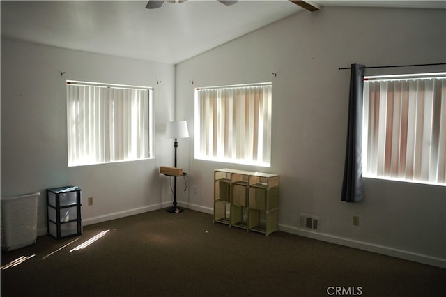 unfurnished bedroom featuring a ceiling fan, carpet floors, baseboards, lofted ceiling, and visible vents