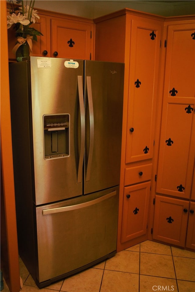 kitchen with light tile patterned flooring and stainless steel fridge