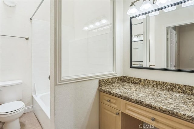 bathroom featuring toilet, vanity, tile patterned floors, and bathing tub / shower combination