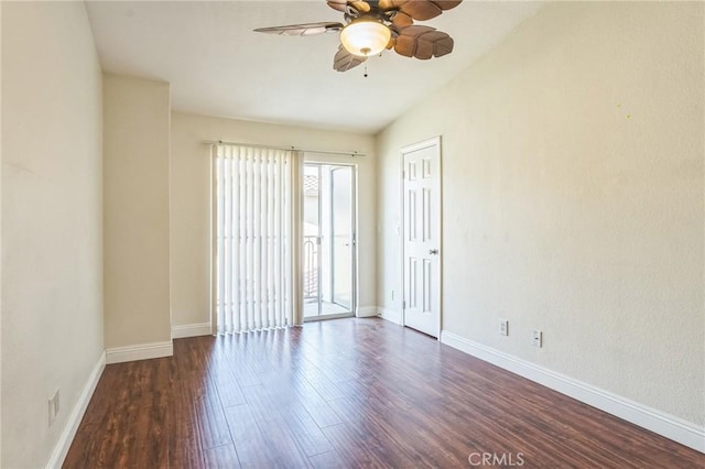 spare room featuring lofted ceiling, wood finished floors, a ceiling fan, and baseboards
