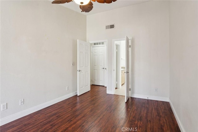 unfurnished bedroom featuring wood finished floors, visible vents, and baseboards