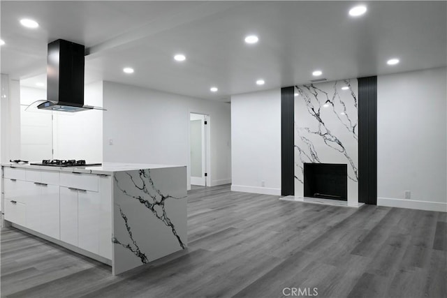 unfurnished living room with recessed lighting, baseboards, and light wood finished floors
