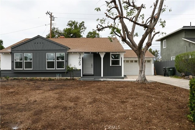 ranch-style home featuring board and batten siding, covered porch, driveway, a garage, and fence