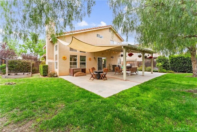 back of property featuring a lawn, a fenced backyard, a chimney, and stucco siding
