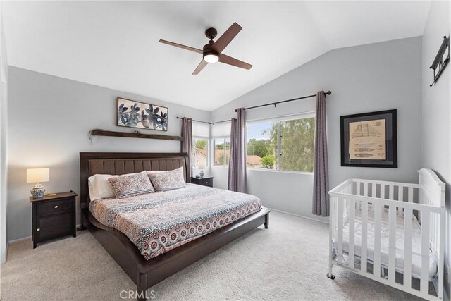 bedroom featuring vaulted ceiling, a ceiling fan, baseboards, and light carpet