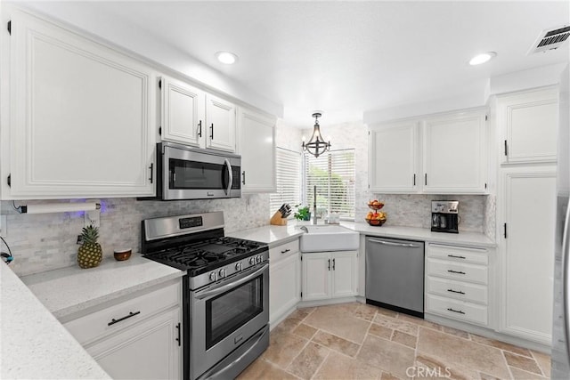 kitchen with white cabinetry, stainless steel appliances, and a sink