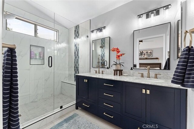 bathroom featuring double vanity, tile patterned flooring, a marble finish shower, and a sink