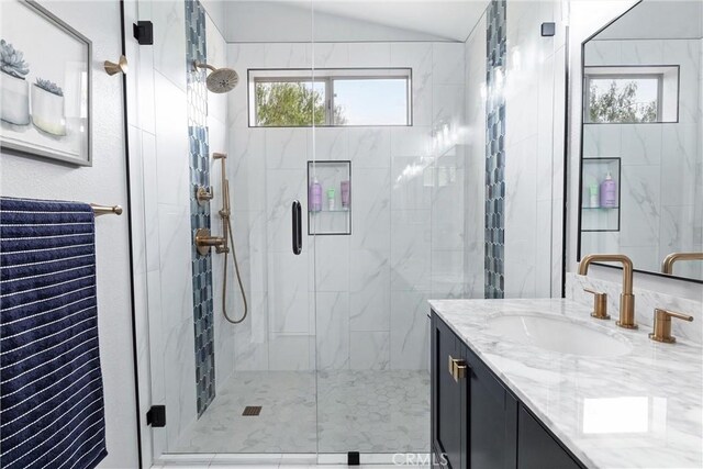 bathroom with vaulted ceiling, vanity, and a stall shower
