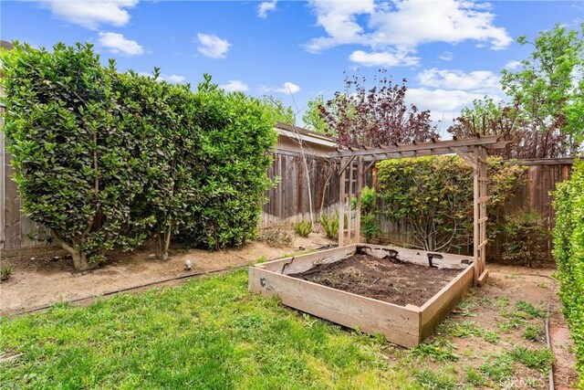 view of yard with a garden and fence