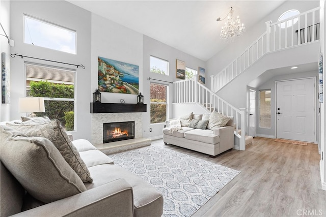 living area with a high ceiling, a wealth of natural light, and stairway