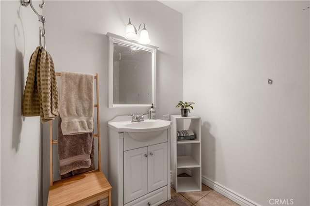 bathroom featuring tile patterned flooring, baseboards, and vanity