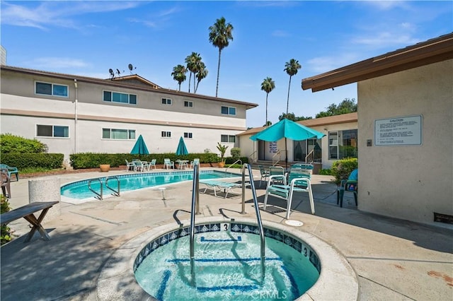 community pool featuring a community hot tub and a patio