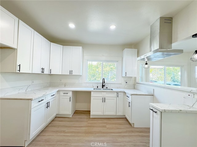 873 N Towne Ave, Pomona, CA 91767 - kitchen with extractor fan, a sink, light stone counters, light wood-style floors, and recessed lighting