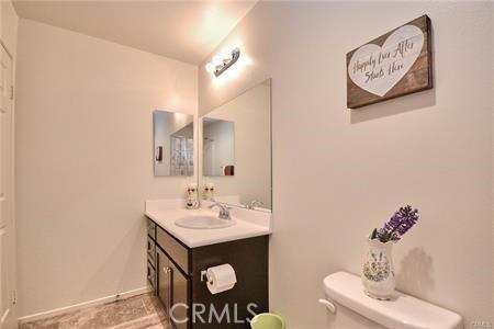 5374 Mission Rock Way, Jurupa Valley, CA 92509 - bathroom with baseboards, toilet, and vanity