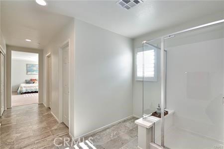5374 Mission Rock Way, Jurupa Valley, CA 92509 - bathroom with a shower stall, baseboards, and visible vents