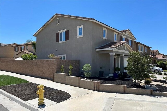 5374 Mission Rock Way, Jurupa Valley, CA 92509 - view of property exterior with fence, a residential view, and stucco siding