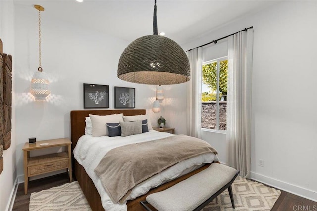 bedroom featuring wood finished floors and baseboards