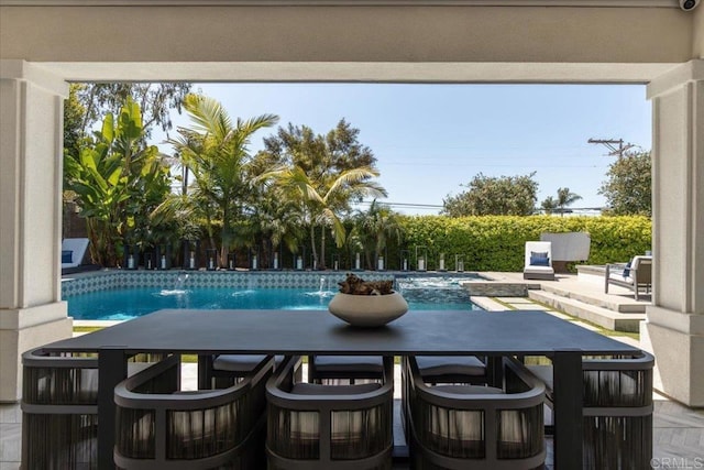 exterior space with a fenced in pool and outdoor dining area