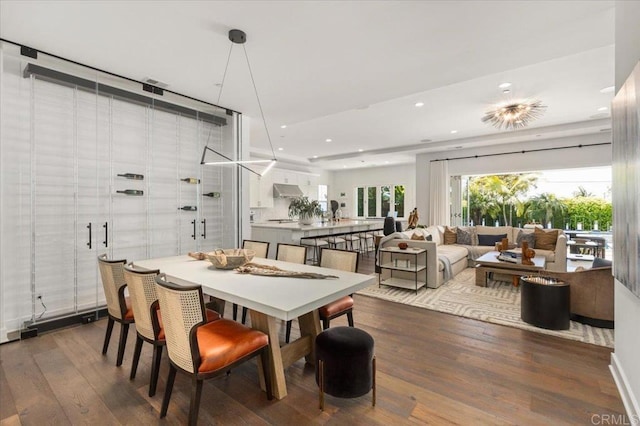 dining area with wood finished floors and recessed lighting