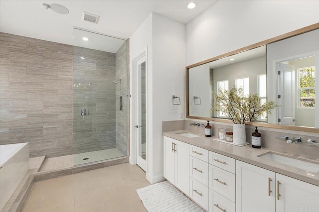 full bathroom featuring recessed lighting, a shower stall, visible vents, and a sink