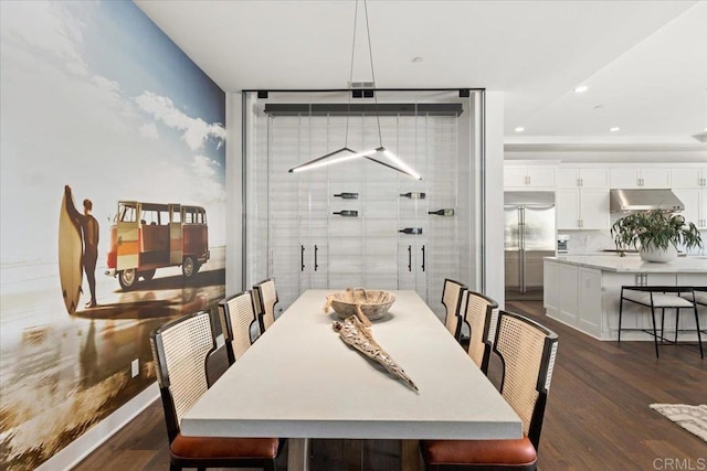dining room with dark wood-style flooring and recessed lighting
