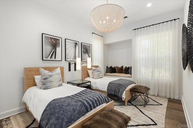 bedroom featuring baseboards, a chandelier, wood finished floors, and recessed lighting