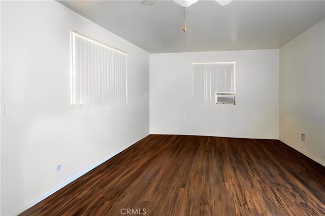 3192 Lytle Creek Rd, Lytle Creek, CA 92358 - spare room with wood finished floors, ceiling fan, and an AC wall unit