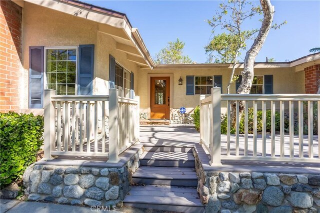 3192 Lytle Creek Rd, Lytle Creek, CA 92358 - view of exterior entry with stucco siding and covered porch