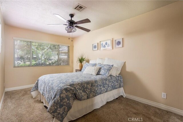 3192 Lytle Creek Rd, Lytle Creek, CA 92358 - carpeted bedroom featuring baseboards, a textured ceiling, and a ceiling fan
