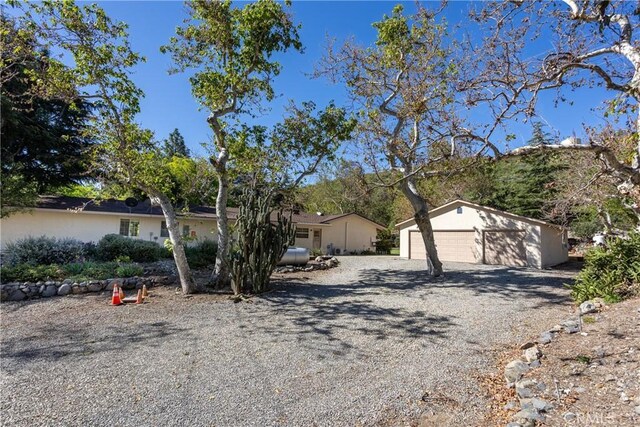 3192 Lytle Creek Rd, Lytle Creek, CA 92358 - ranch-style house featuring a detached garage and an outbuilding