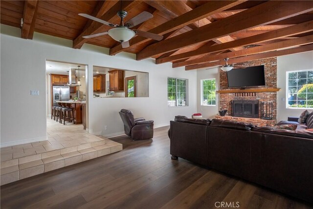3192 Lytle Creek Rd, Lytle Creek, CA 92358 - living area with ceiling fan, wooden ceiling, a brick fireplace, dark wood-type flooring, and baseboards