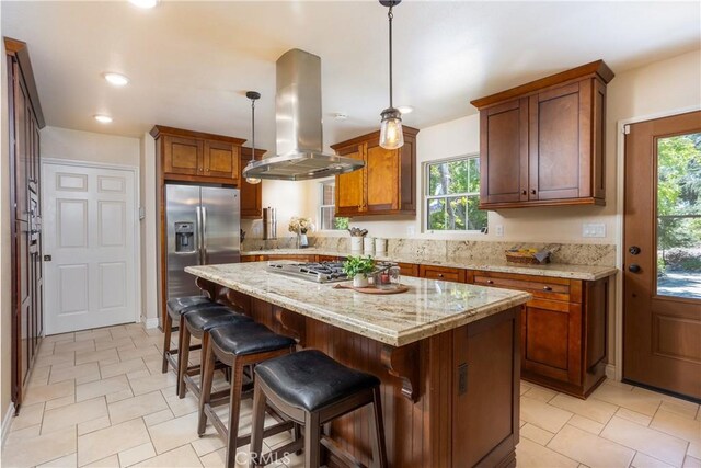 3192 Lytle Creek Rd, Lytle Creek, CA 92358 - kitchen with island range hood, stainless steel appliances, a center island, brown cabinetry, and recessed lighting
