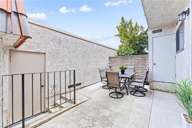 view of patio with outdoor dining area and fence