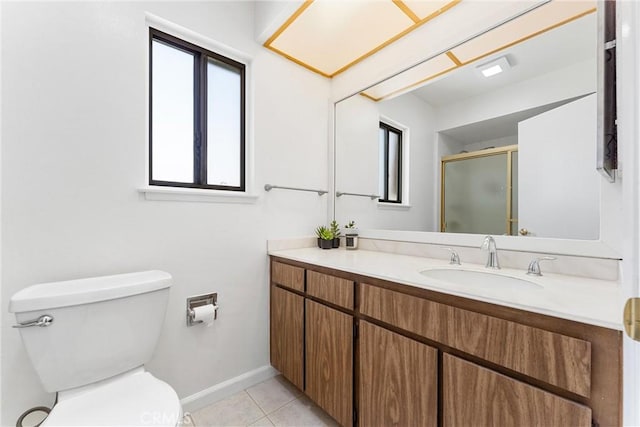 bathroom with a shower stall, vanity, toilet, baseboards, and tile patterned flooring