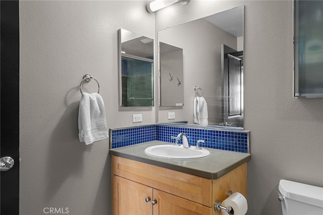 12842 Palm St Unit 301, Garden Grove, CA 92840 - bathroom with toilet, vanity, and decorative backsplash