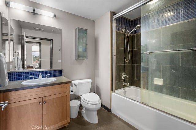 12842 Palm St Unit 301, Garden Grove, CA 92840 - bathroom featuring tile patterned flooring, enclosed tub / shower combo, toilet, vanity, and decorative backsplash