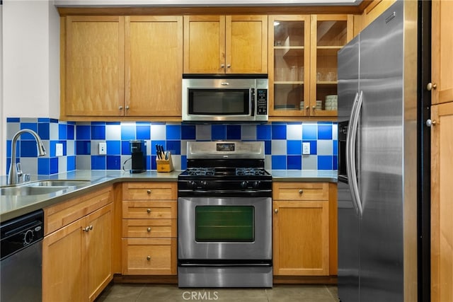 12842 Palm St Unit 301, Garden Grove, CA 92840 - kitchen with tile patterned floors, a sink, decorative backsplash, glass insert cabinets, and appliances with stainless steel finishes