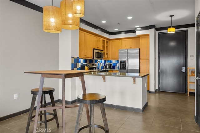 12842 Palm St Unit 301, Garden Grove, CA 92840 - kitchen featuring appliances with stainless steel finishes, a peninsula, glass insert cabinets, a breakfast bar, and dark tile patterned flooring