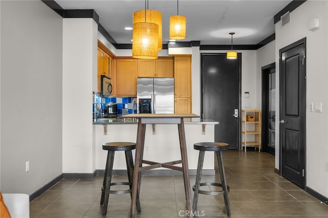 12842 Palm St Unit 301, Garden Grove, CA 92840 - kitchen with stainless steel refrigerator with ice dispenser, a breakfast bar area, a peninsula, pendant lighting, and brown cabinets