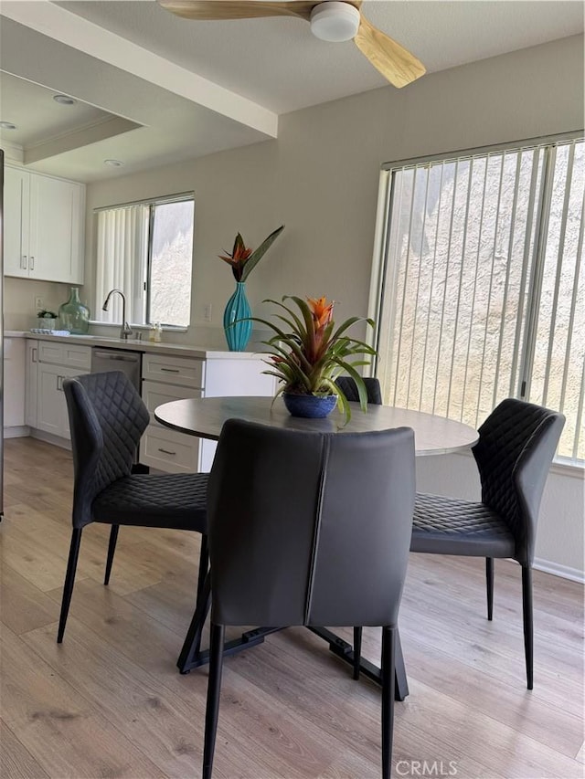dining space with light wood-style floors, baseboards, and ceiling fan