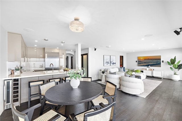 dining area with recessed lighting, baseboards, and dark wood-type flooring