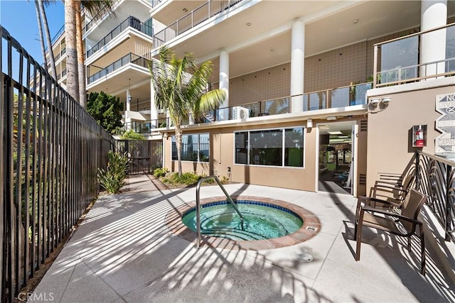 exterior space featuring fence and a hot tub
