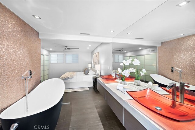 bathroom with a soaking tub, double vanity, visible vents, an enclosed shower, and a ceiling fan