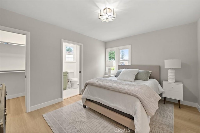 347 E Barkley Ave, Orange, CA 92867 - bedroom featuring a closet, a spacious closet, ensuite bath, light wood finished floors, and baseboards