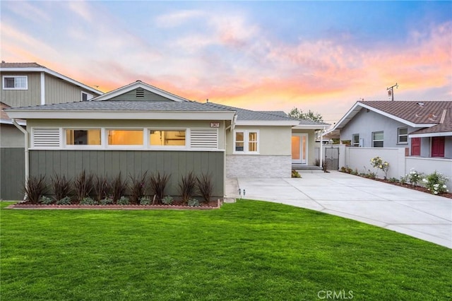 347 E Barkley Ave, Orange, CA 92867 - view of front of property featuring fence, stucco siding, driveway, stone siding, and a lawn