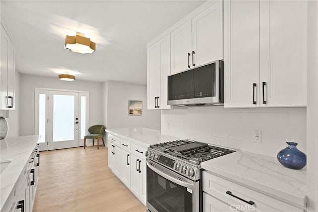 347 E Barkley Ave, Orange, CA 92867 - kitchen with tasteful backsplash, stainless steel appliances, and white cabinetry
