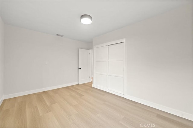 347 E Barkley Ave, Orange, CA 92867 - unfurnished bedroom with baseboards, visible vents, light wood-style floors, and a closet