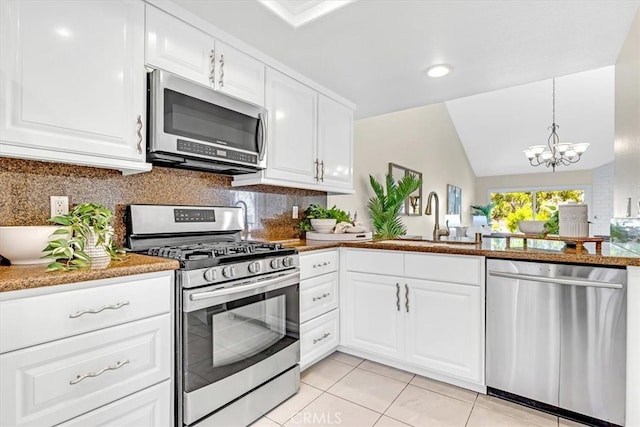 86 Sandpiper Unit 17, Irvine, CA 92604 - kitchen with light tile patterned floors, a sink, decorative backsplash, appliances with stainless steel finishes, and a notable chandelier