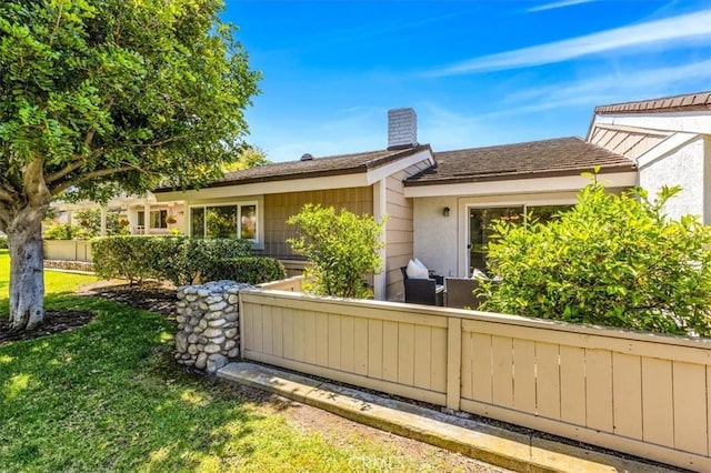 86 Sandpiper Unit 17, Irvine, CA 92604 - back of property featuring fence, a chimney, a yard, and stucco siding